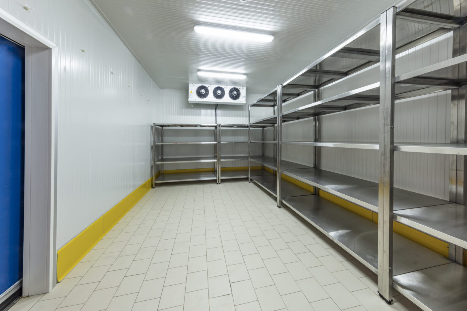 A room with many shelves and tiled floor