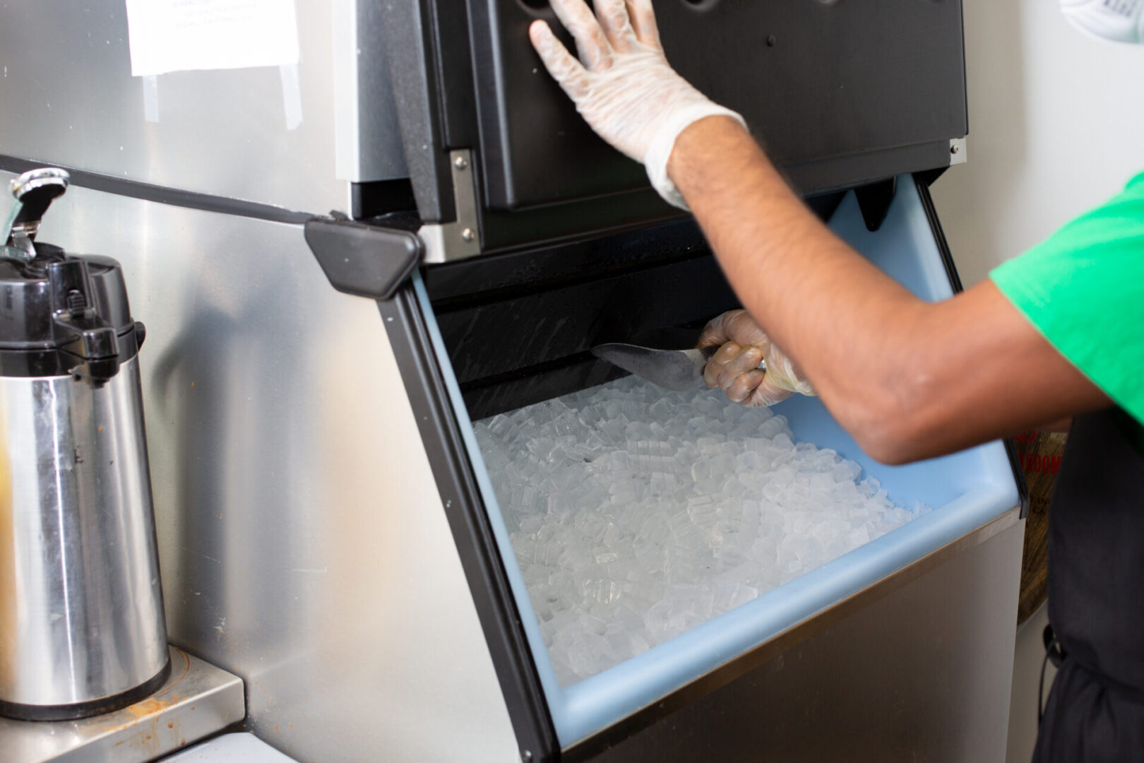 A person in white gloves opening an ice chest.